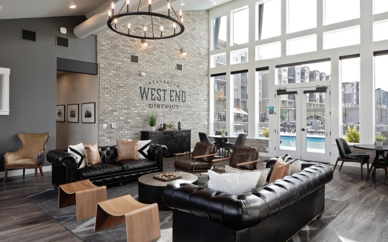 a living room with a large stone wall and a large chandelier