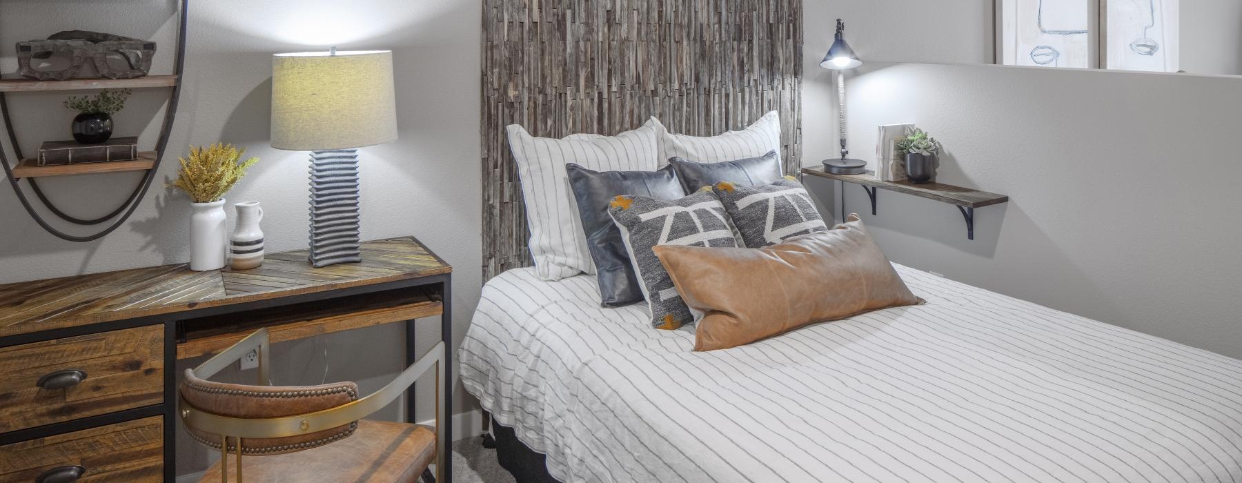 a bedroom with a bed and a desk