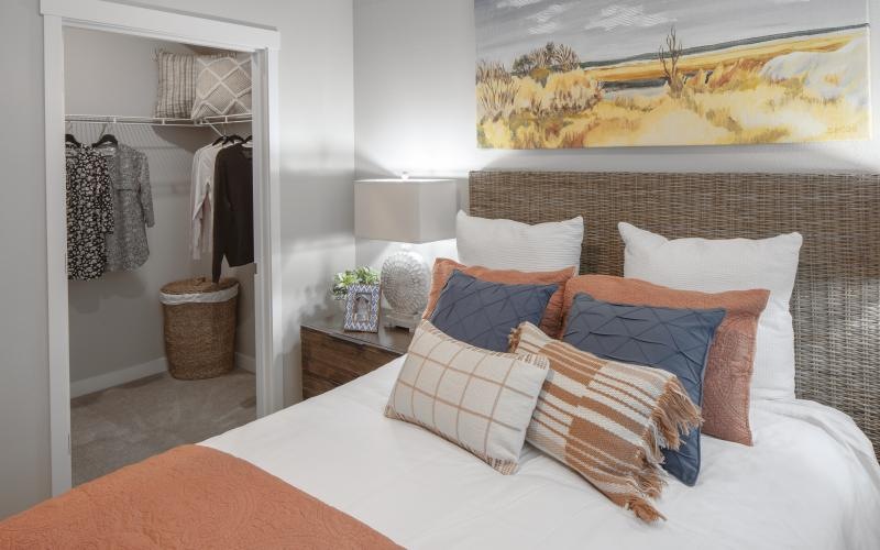 a bedroom with a bed and a painting on the wall