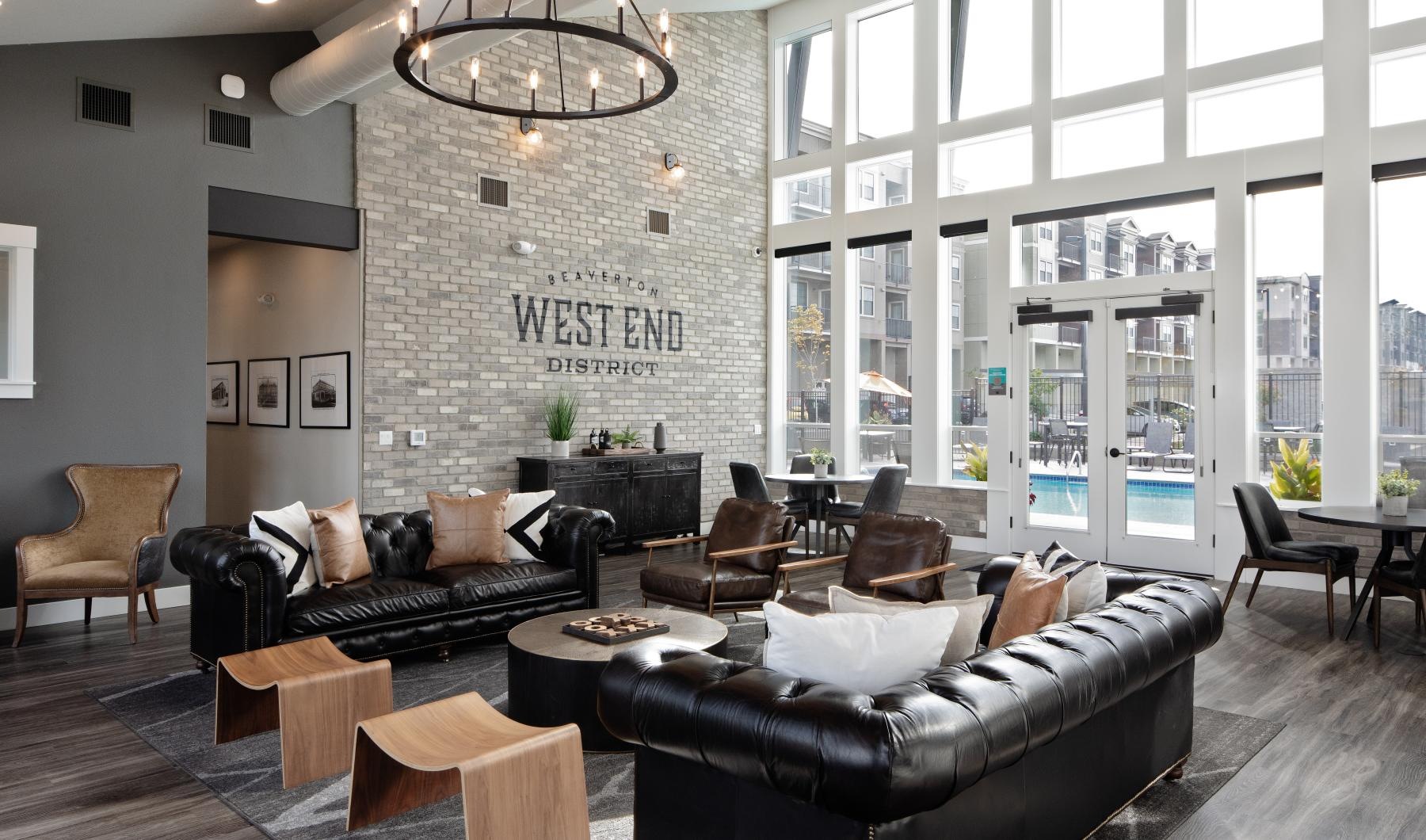 a living room with a large stone wall and a large chandelier